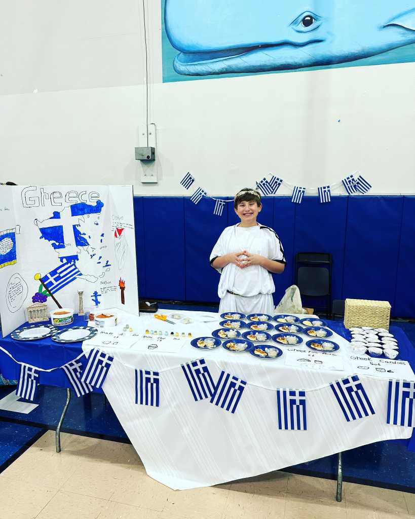 Hosting a Greek table at his new school's International Bazaar. 