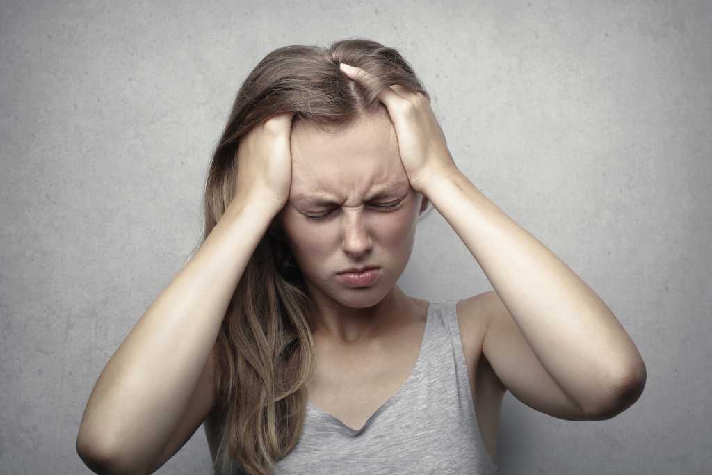 Women with headache from decreasing caffeine.