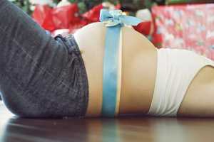 Pregnant belly with blue bow
