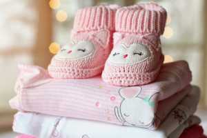 Pink baby blankets and little knit booties.