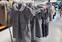 School uniforms hang in the store, just waiting to be purchased for more than you will expect!