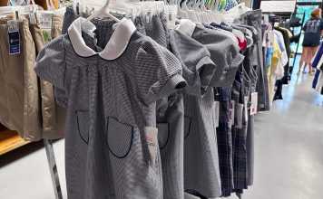School uniforms hang in the store, just waiting to be purchased for more than you will expect!